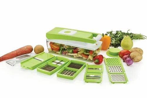 Green kitchen chopper with various attachments on a white background